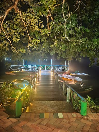 Enchanting night view of the lakeside dining area with beautiful reflections on the water.